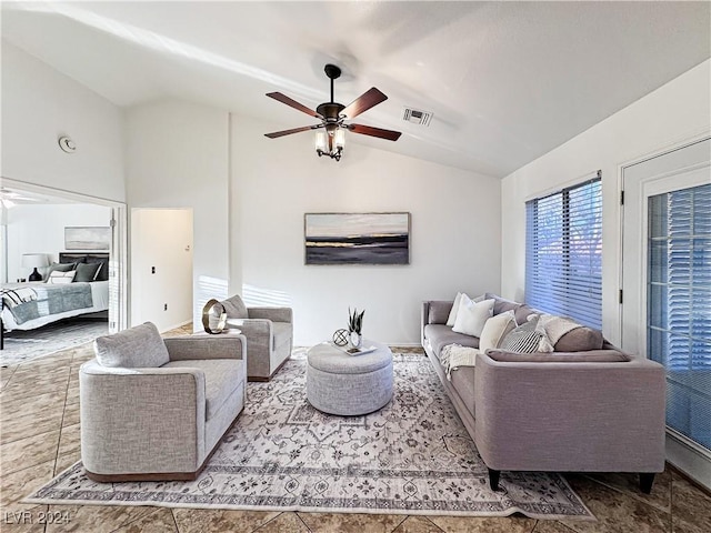 living room with lofted ceiling, visible vents, and ceiling fan