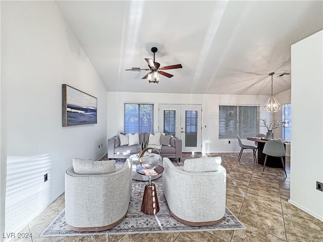 tiled living room with lofted ceiling, baseboards, french doors, and ceiling fan with notable chandelier