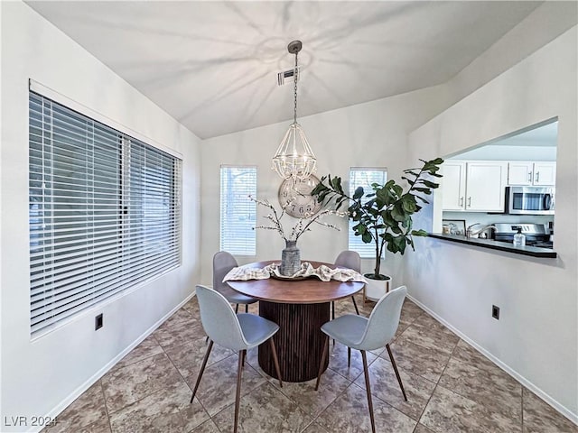 dining area with a healthy amount of sunlight, baseboards, a chandelier, and vaulted ceiling