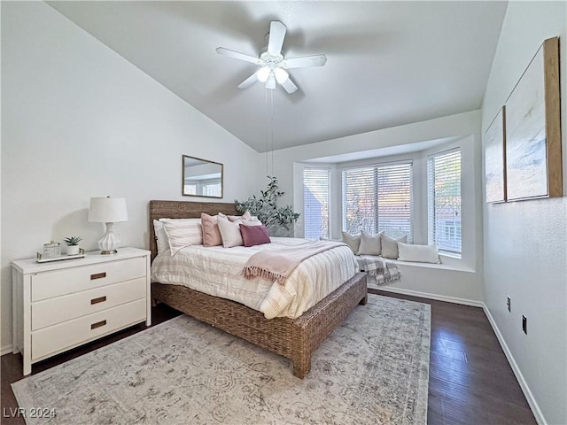 bedroom with lofted ceiling, ceiling fan, baseboards, and dark wood-type flooring