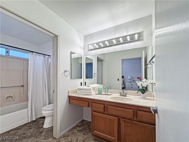 bathroom with a textured ceiling, tile patterned flooring, toilet, vanity, and shower / bath combo with shower curtain