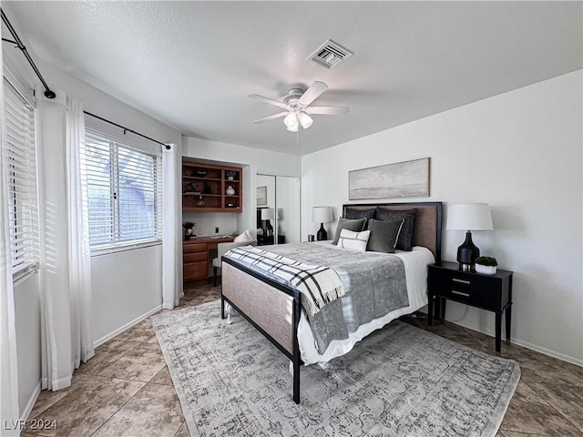 bedroom featuring baseboards, visible vents, and a ceiling fan