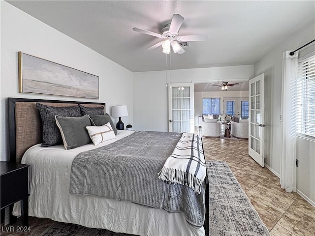 bedroom featuring french doors, a ceiling fan, and baseboards