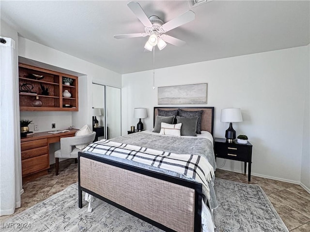 bedroom featuring a ceiling fan, built in study area, visible vents, and baseboards