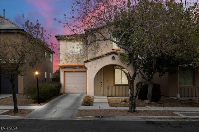 mediterranean / spanish house with a garage