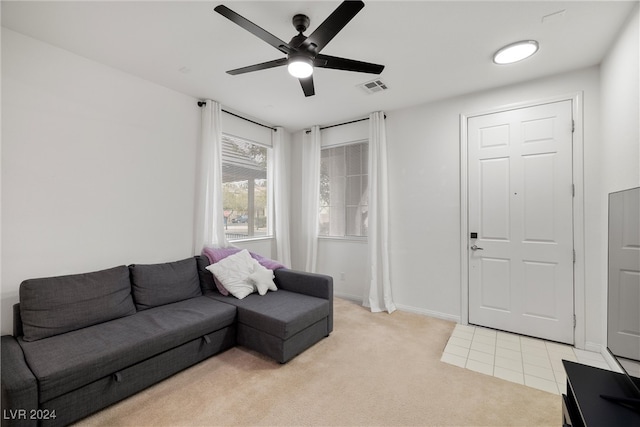 living room with ceiling fan and light colored carpet