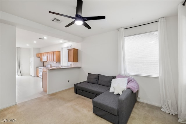 carpeted living room featuring ceiling fan