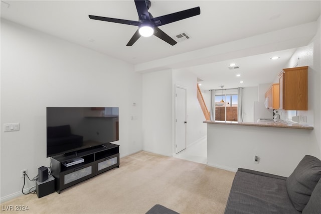 carpeted living room featuring ceiling fan