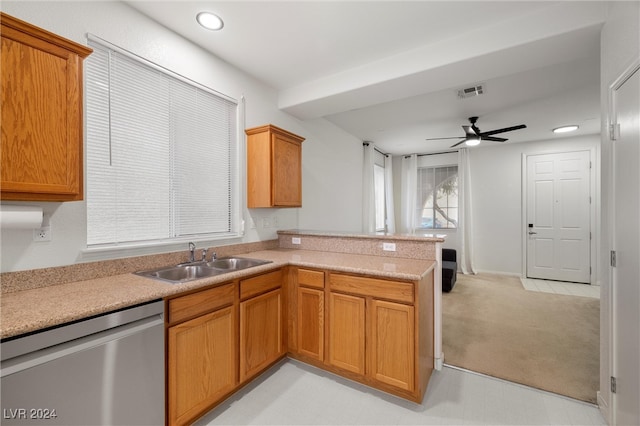 kitchen featuring kitchen peninsula, light colored carpet, ceiling fan, sink, and dishwasher