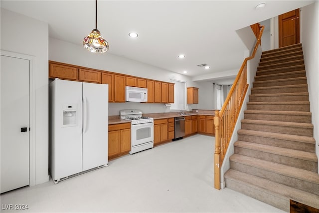 kitchen featuring pendant lighting and white appliances