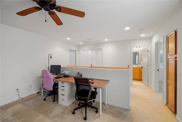 carpeted home office featuring ceiling fan