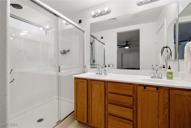 bathroom with vanity, ceiling fan, and a shower with shower door