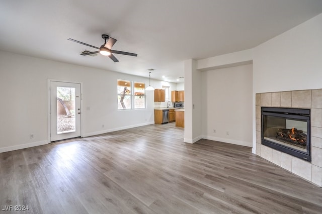 unfurnished living room featuring wood-type flooring and ceiling fan