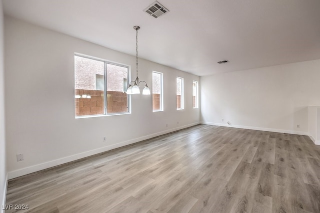 interior space with a notable chandelier and light wood-type flooring