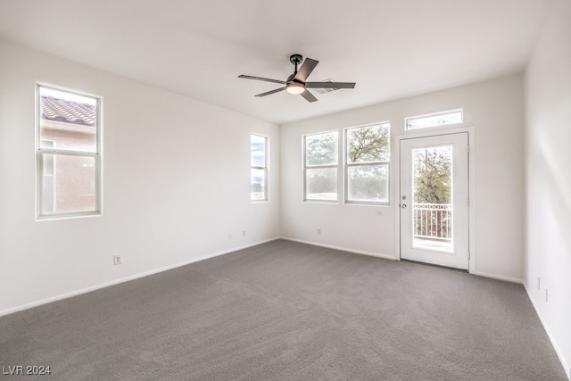 empty room with carpet flooring, plenty of natural light, and ceiling fan