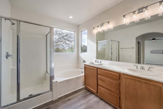 bathroom featuring hardwood / wood-style floors, vanity, separate shower and tub, and ceiling fan