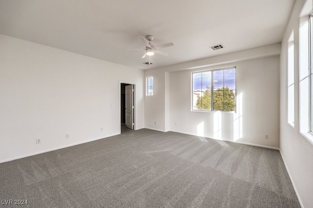 unfurnished room with carpet flooring and ceiling fan