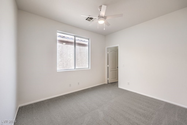 spare room with carpet floors and ceiling fan