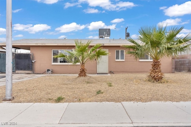 ranch-style home with cooling unit