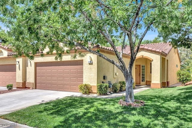 view of front of home with a garage and a front lawn