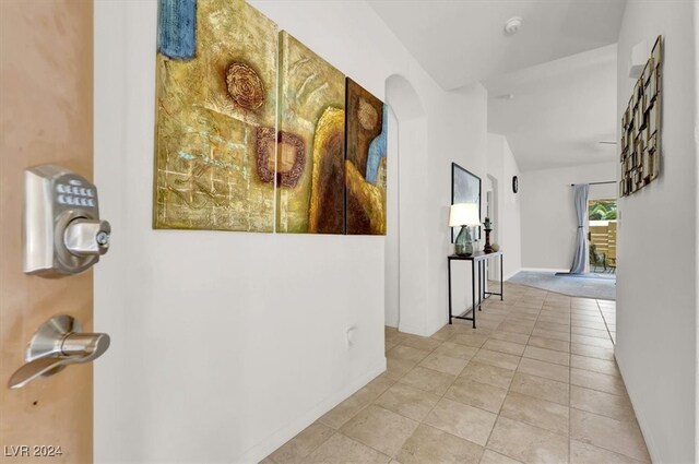 corridor featuring light tile patterned floors