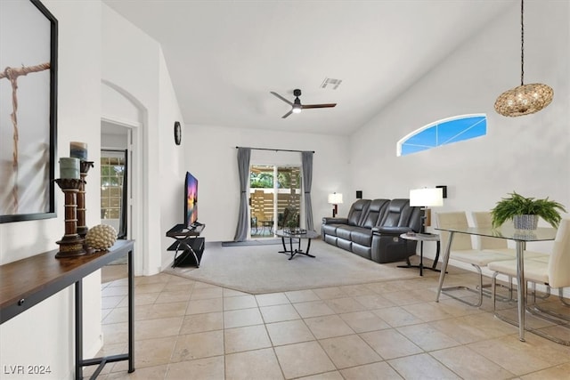 carpeted living room featuring ceiling fan and high vaulted ceiling