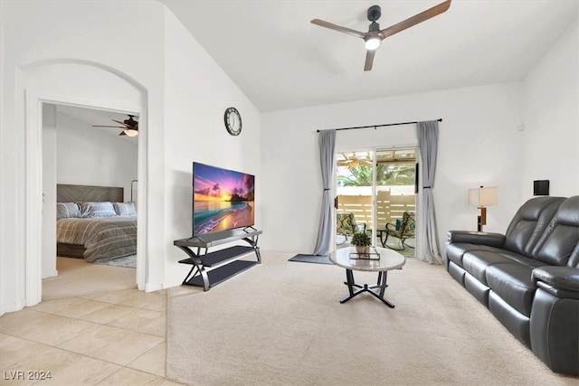 tiled living room with ceiling fan and lofted ceiling