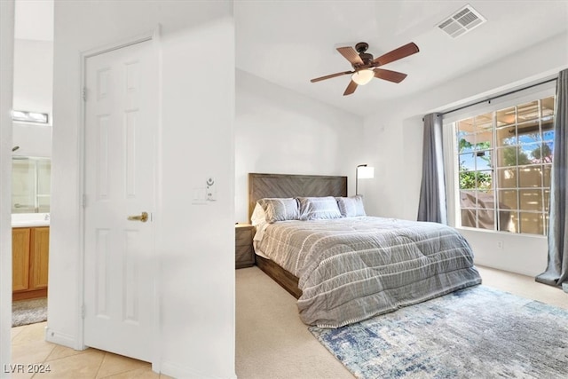 carpeted bedroom with ceiling fan and connected bathroom