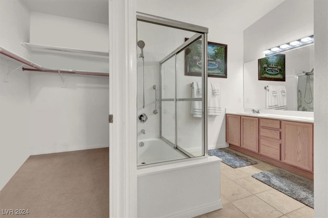 bathroom featuring vanity, tile patterned floors, and bath / shower combo with glass door