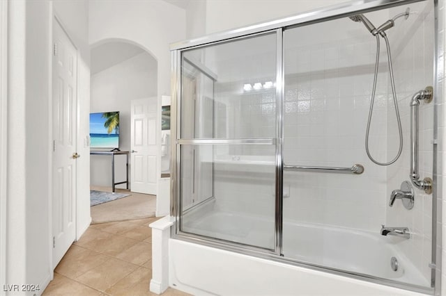 bathroom with combined bath / shower with glass door and tile patterned floors