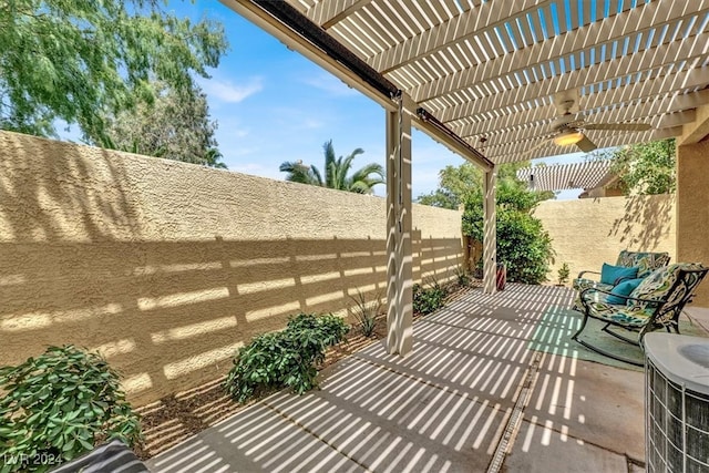 view of patio / terrace with ceiling fan, a pergola, and central AC