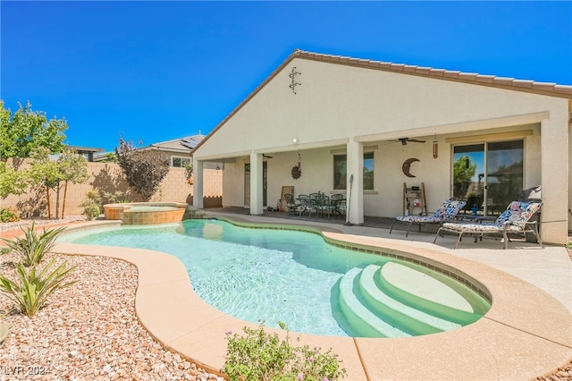 view of pool with a ceiling fan, a pool with connected hot tub, a fenced backyard, and a patio