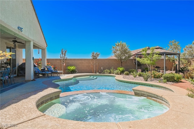 view of swimming pool featuring a fenced in pool, a ceiling fan, a fenced backyard, an in ground hot tub, and a gazebo