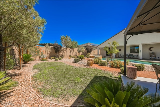 view of yard featuring a patio area, a fenced backyard, and a fenced in pool