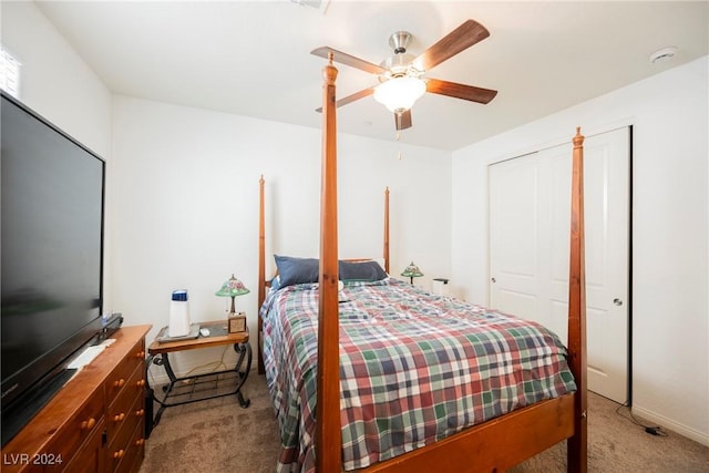 bedroom featuring a ceiling fan, a closet, and light carpet