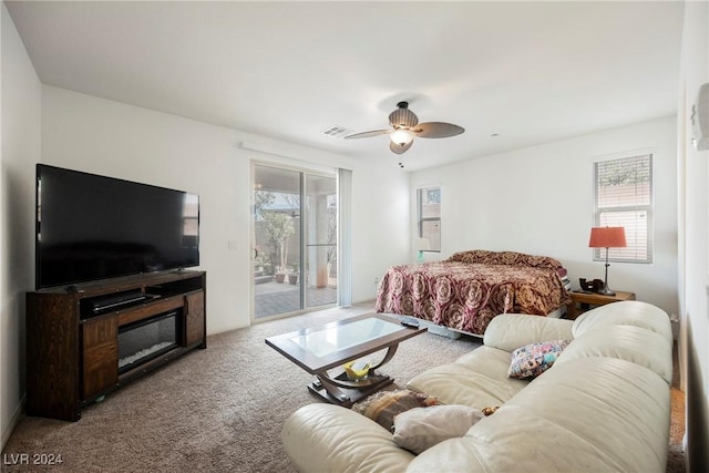 carpeted bedroom featuring access to outside, multiple windows, ceiling fan, and visible vents