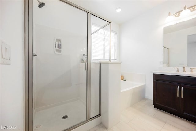 full bathroom with a stall shower, tile patterned flooring, a bath, and vanity