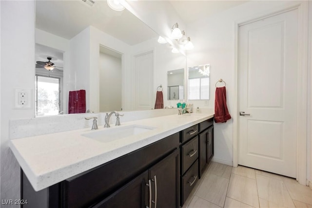 bathroom featuring a healthy amount of sunlight, a sink, and double vanity