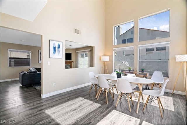8213 Grassy Point Cir, Las Vegas, NV 89145 - dining room featuring wood finished floors and a towering ceiling