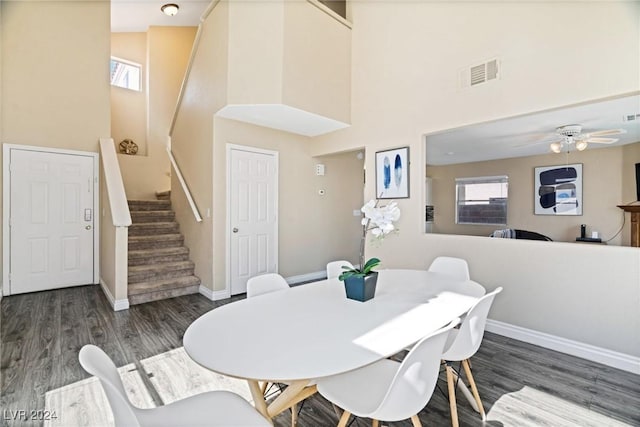 8213 Grassy Point Cir, Las Vegas, NV 89145 - dining room featuring a high ceiling, wood finished floors, stairway, and ceiling fan