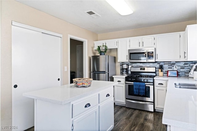 8213 Grassy Point Cir, Las Vegas, NV 89145 - kitchen with stainless steel appliances, light countertops, dark wood finished floors, and white cabinetry