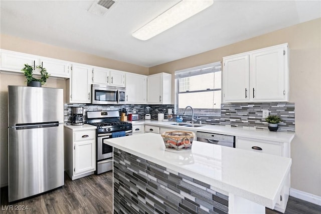 8213 Grassy Point Cir, Las Vegas, NV 89145 - kitchen featuring appliances with stainless steel finishes, dark wood-style floors, white cabinetry, and light countertops