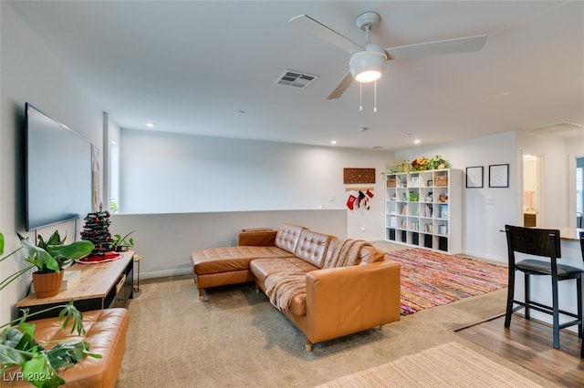 carpeted living room featuring ceiling fan