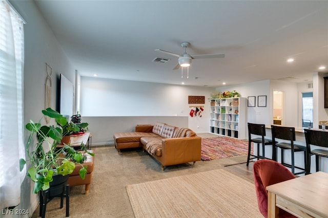 carpeted living room featuring ceiling fan and a healthy amount of sunlight