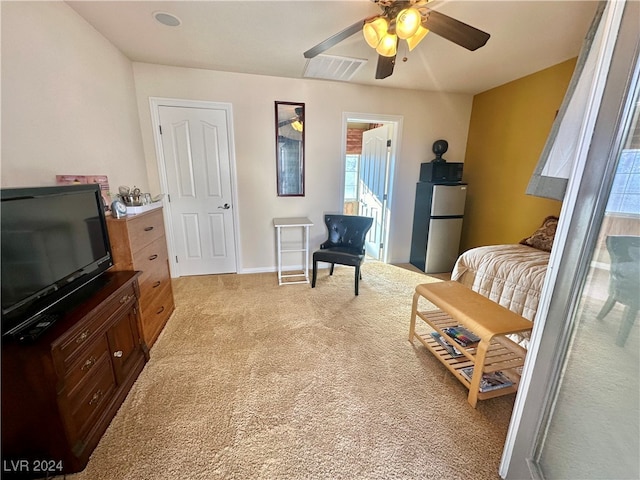 living area featuring light carpet and ceiling fan