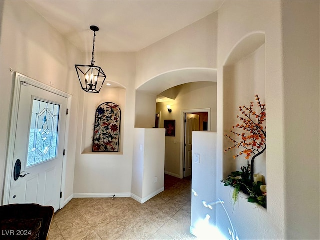 entryway with a notable chandelier