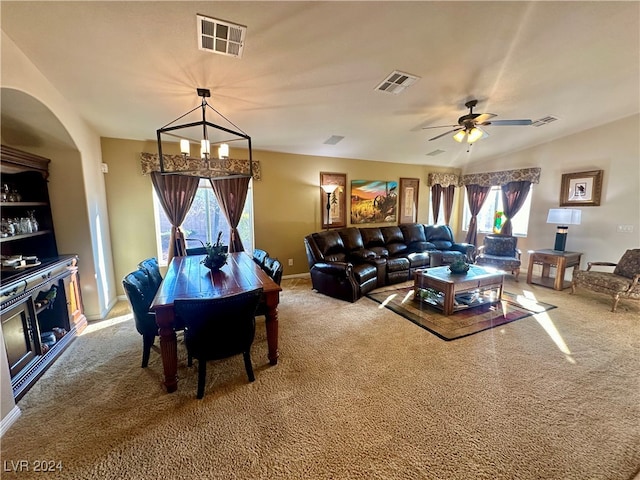 living room with carpet, ceiling fan with notable chandelier, and a wealth of natural light