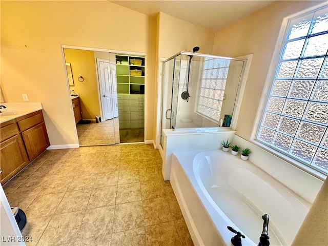 bathroom with tile patterned floors, vanity, and independent shower and bath