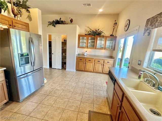 kitchen with light tile patterned floors, sink, and appliances with stainless steel finishes