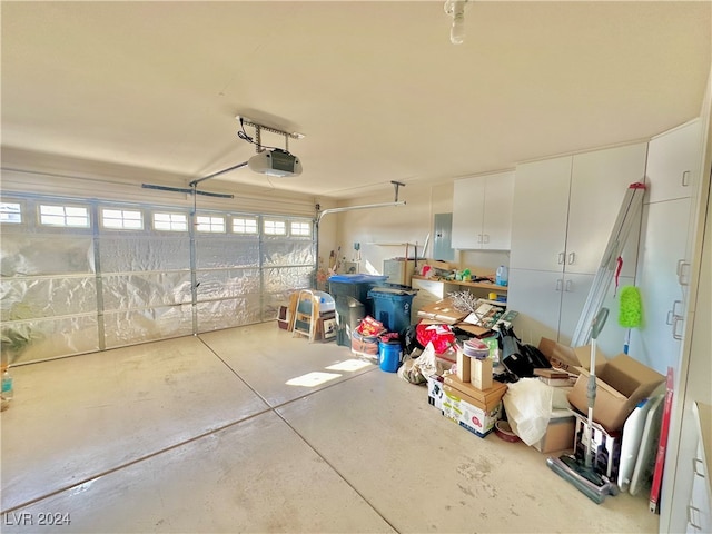 garage featuring electric panel and a garage door opener